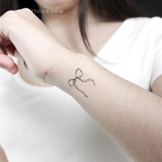 Bow tattoos: Fine line ribbon bow tattoo