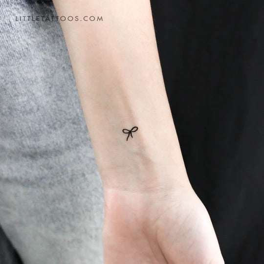 Hailey Bieber's Tattoos: Tiny bow tattoo