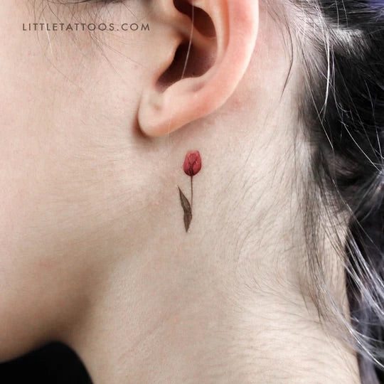 Nature tattoos: Little red tulip tattoo behind the ear